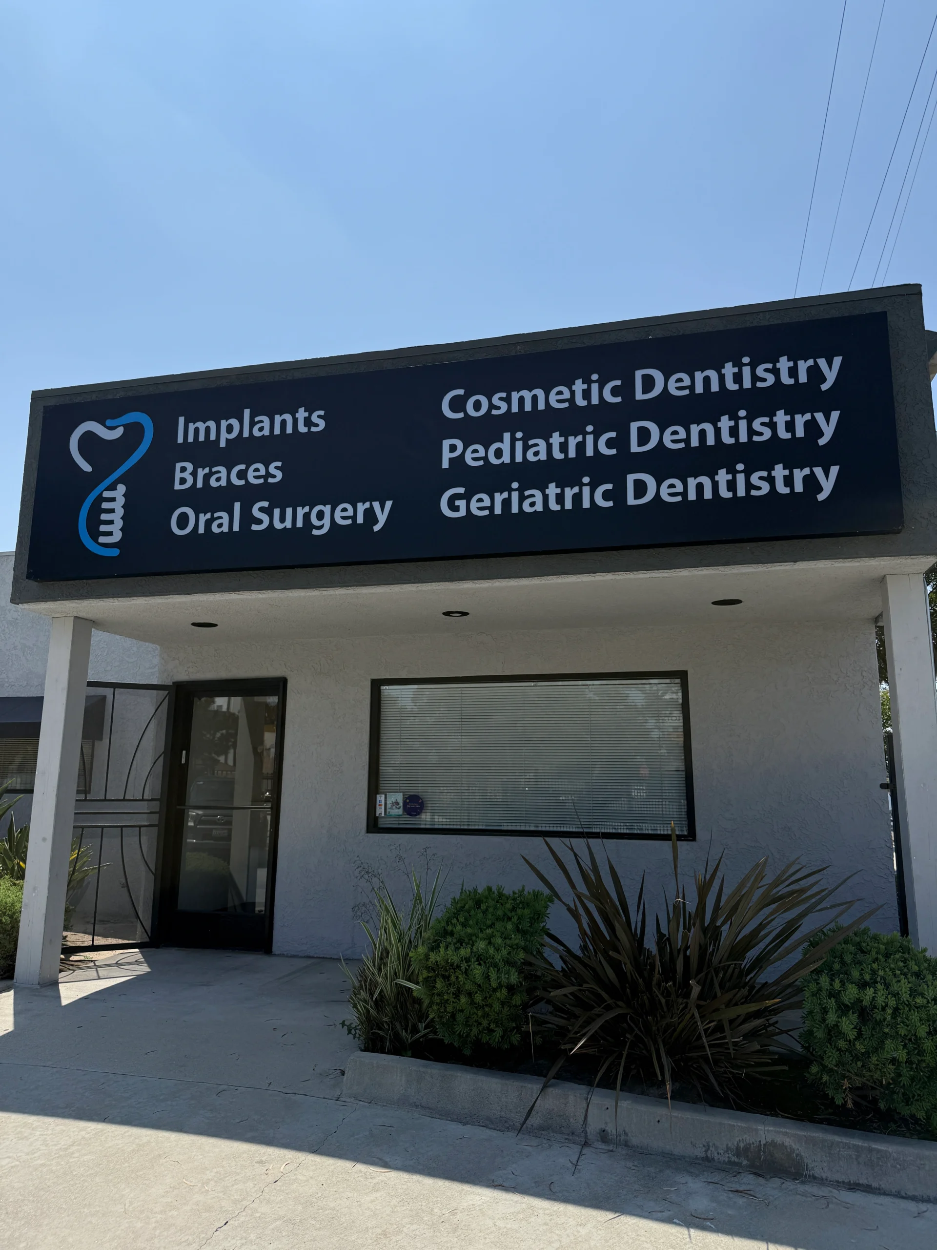 Dental clinic exterior with various services listed.