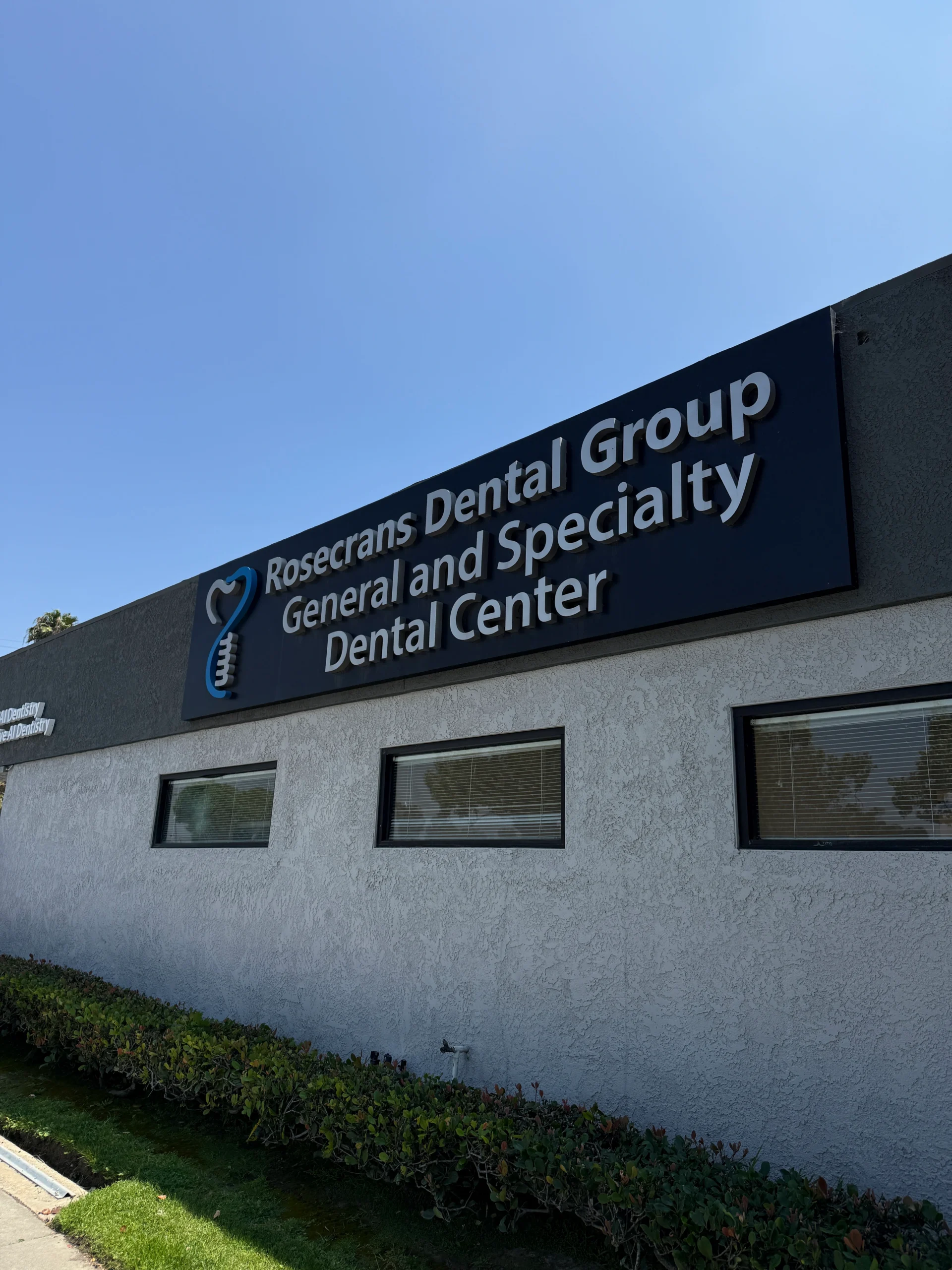 Dental office exterior with clear blue sky.
